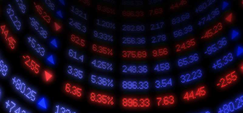 An electronic stock trading wall with moving prices.