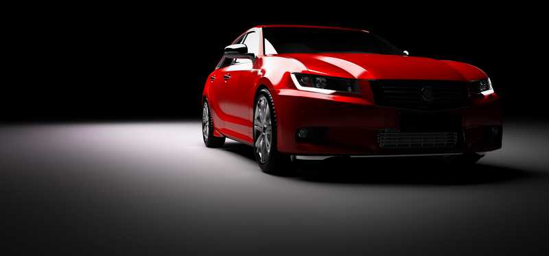 Red sports car in a spotlight.