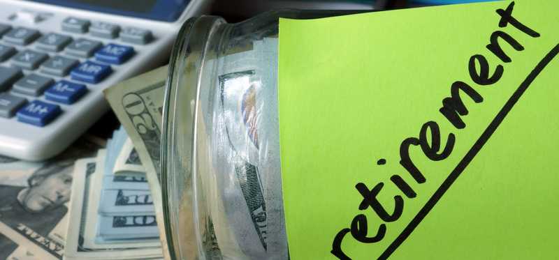 Jar full of cash and labeled Retirement.