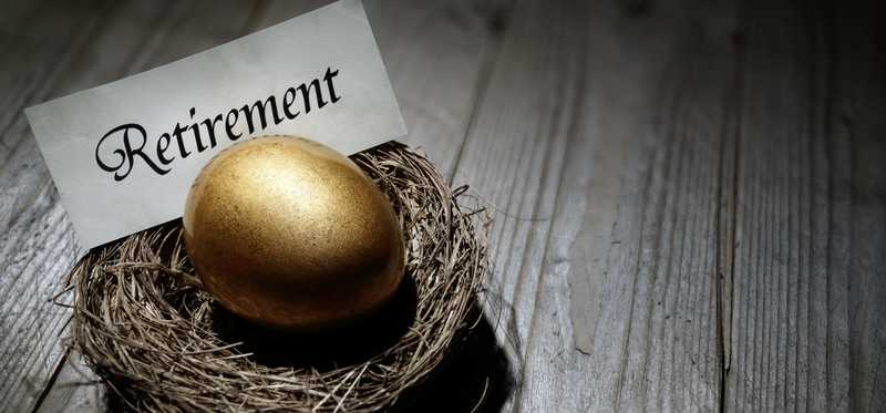 A golden egg in a nest with a sign reading Retirement.