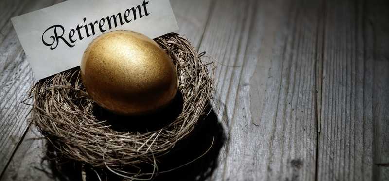 A golden egg in a nest with a sign reading Retirement.