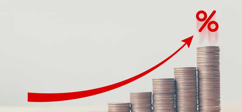 Rising stack of coins with an arrow pointing upward.