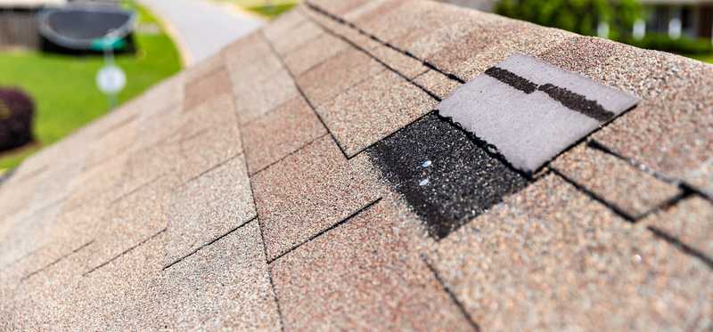 Roof with a damaged shingle.