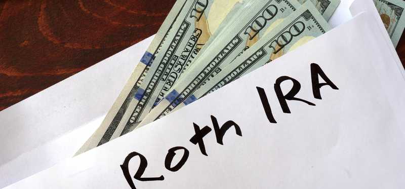 Envelope labeled Roth IRA filled with cash
