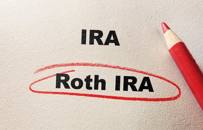 IRA and Roth IRA typed on paper with Roth IRA circled in red pencil.