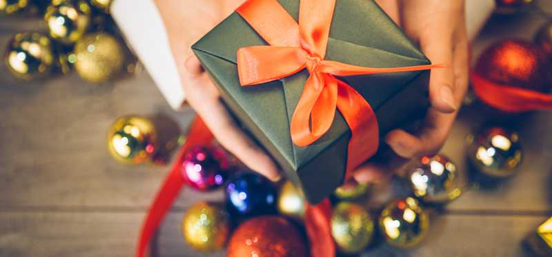 Person holding a Christmas present.