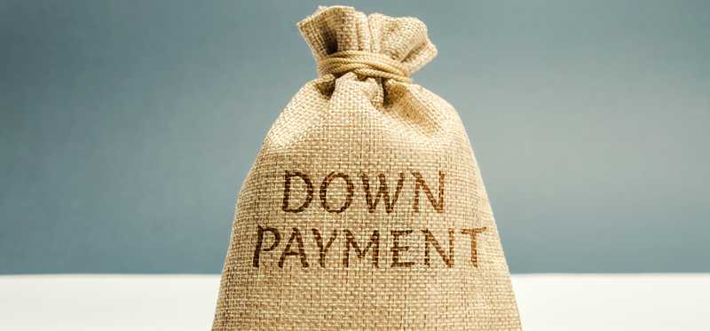 Sack with the words Down Payment written on it and surrounded by coins.