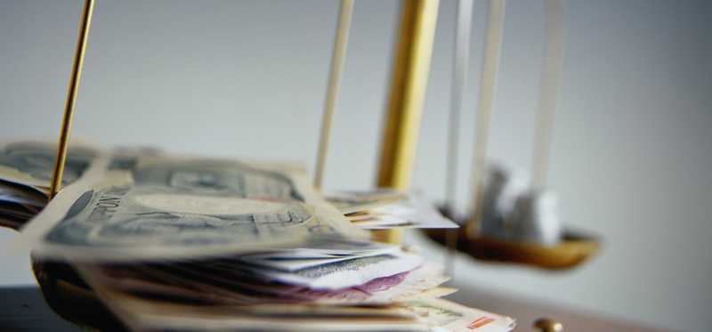 Close-up of scale with money.