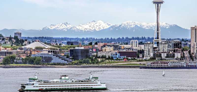 Seattle city skyline with a ferry in the foreground.