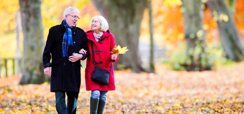 Senior couple enjoying an autumn walk.