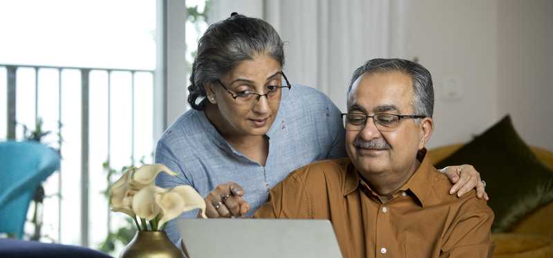 Two people looking at a laptop.