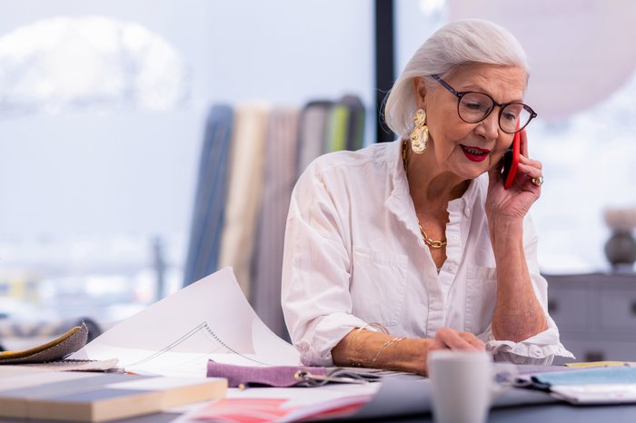 Senior woman working and talking on phone