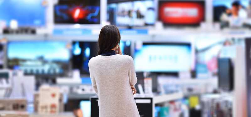 A woman shopping in an electronics store