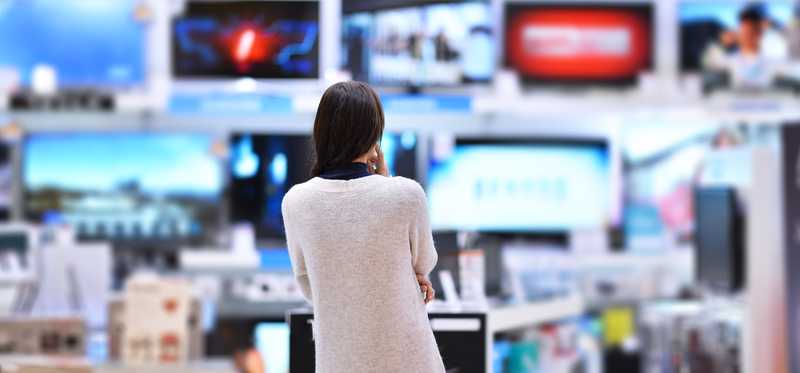 Person shopping in an electronics store.