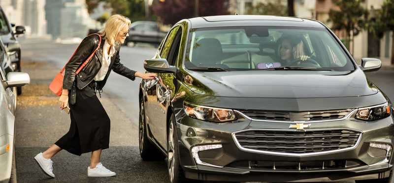 A rider entering a Lyft vehicle.