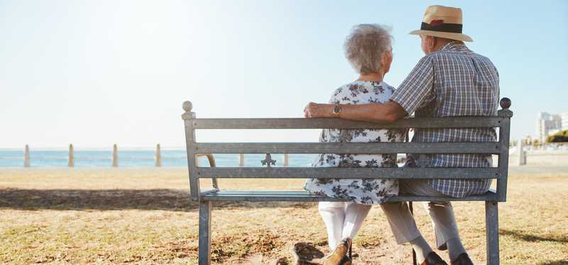 Senior couple sitting on a bench.