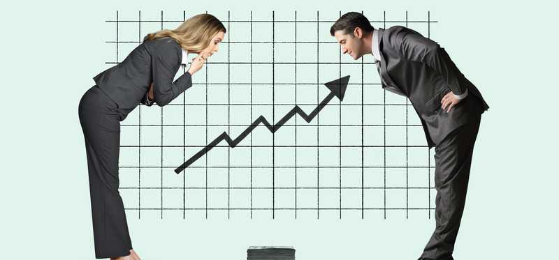 Two businesspeople looking down at upward trend line.