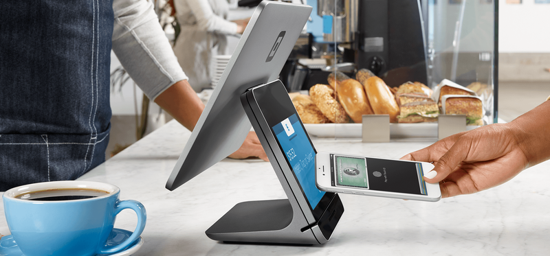 Person uses smartphone to pay at a Square register.
