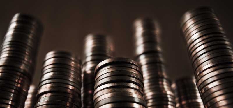 Stacks of coins against dark background