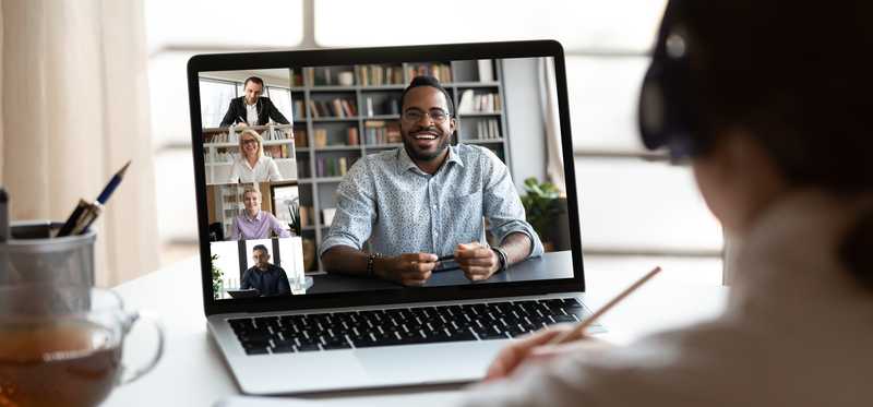 Woman talking to colleagues in videoconference