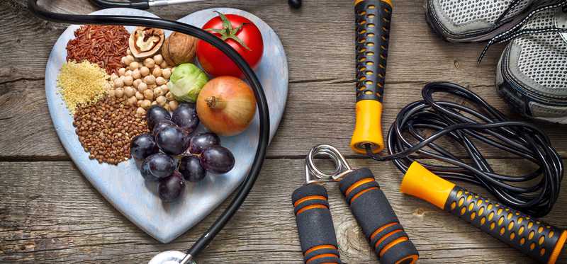 Exercise equipment, a stethoscope and a board of fruit and grains.