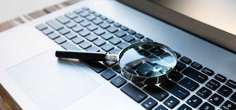 Magnifying glass on laptop keyboard