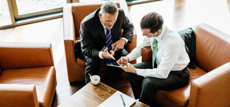 Two businesspeople meeting over coffee.