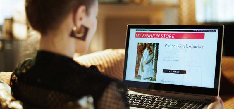 Person sitting at laptop and shopping online.