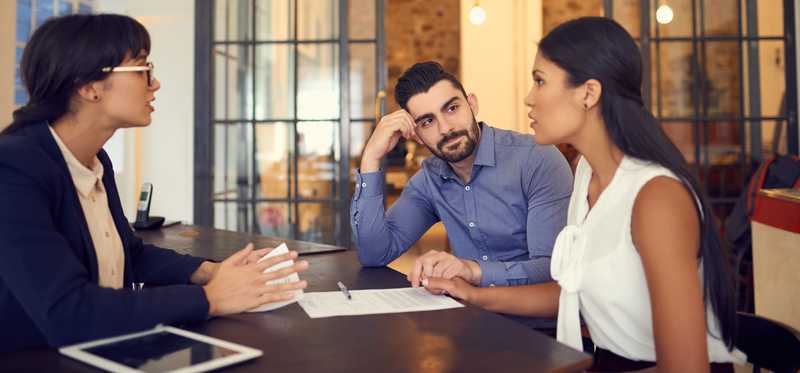 Businesspeople sitting in conference room in open concept office.