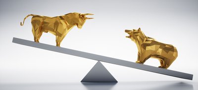 Golden bull and bear facing off while balancing on seesaw.