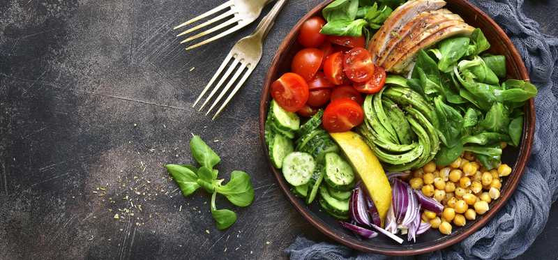 A prepared meal in a bowl showcased on a table.