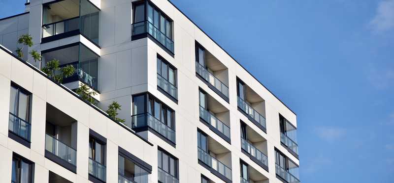 Apartment building under a blue sky.