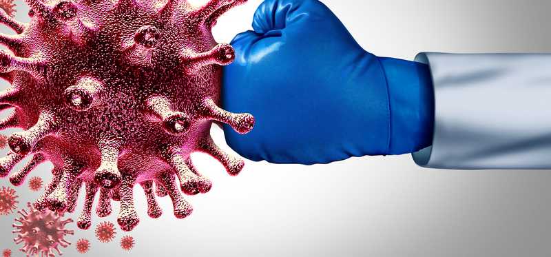 Boxing glove punching large spiked coronavirus cell