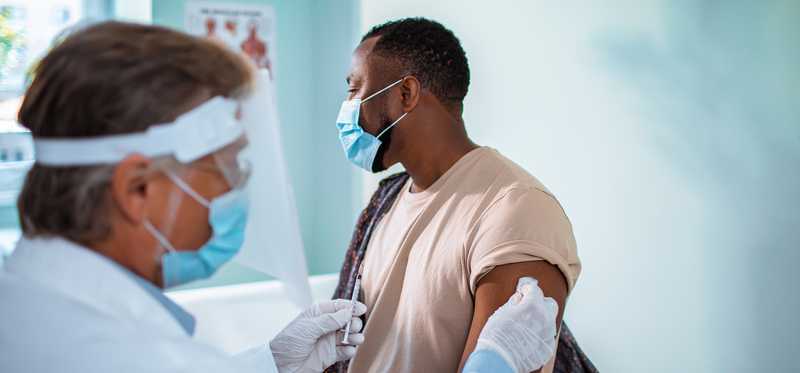 Doctor preparing to administer vaccine to patient