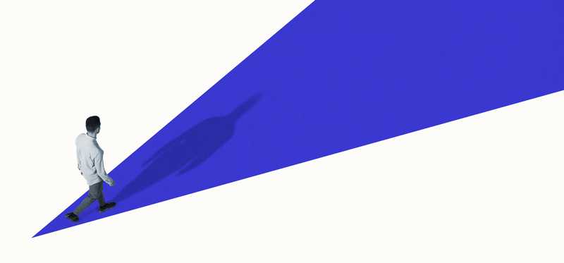 Man standing at beginning of blue road spreading outward against white background