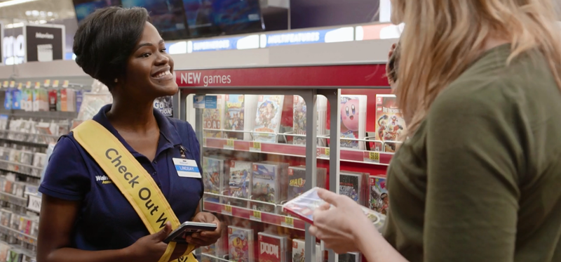 A Walmart employee helping a customer.