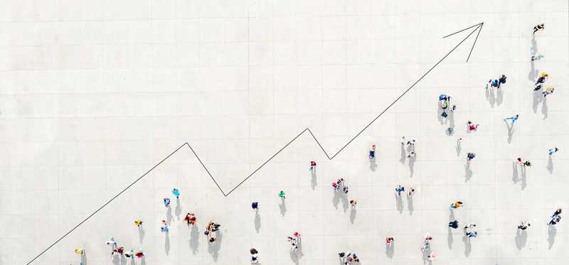 Crowd of people forming against arrow trend line angling upward