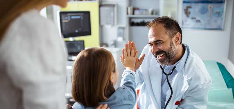 Doctor high-fiving young patient