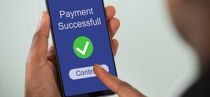 Person using mobile payments processing app to send money.