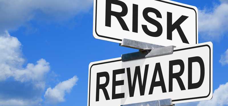 Street signs saying Risk and Reward.
