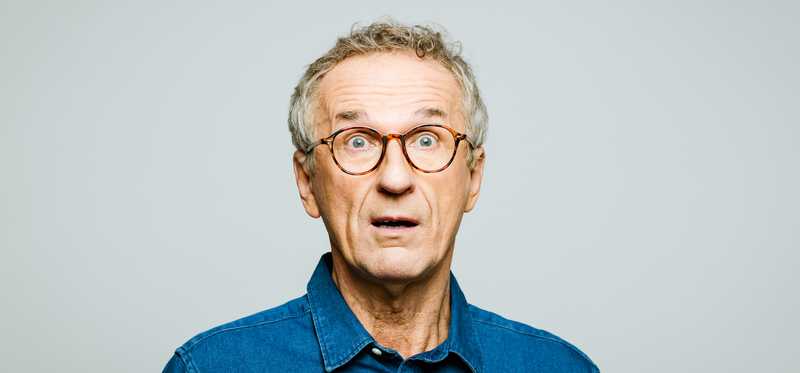 Startled older man in glasses