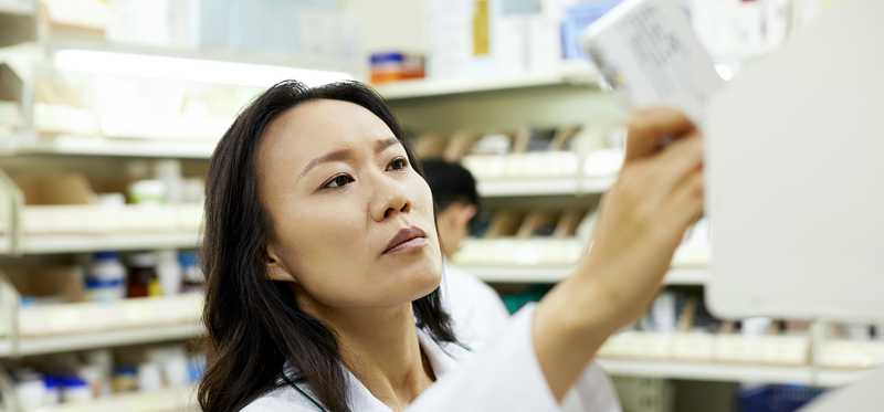 Pharmacist handles prescription.