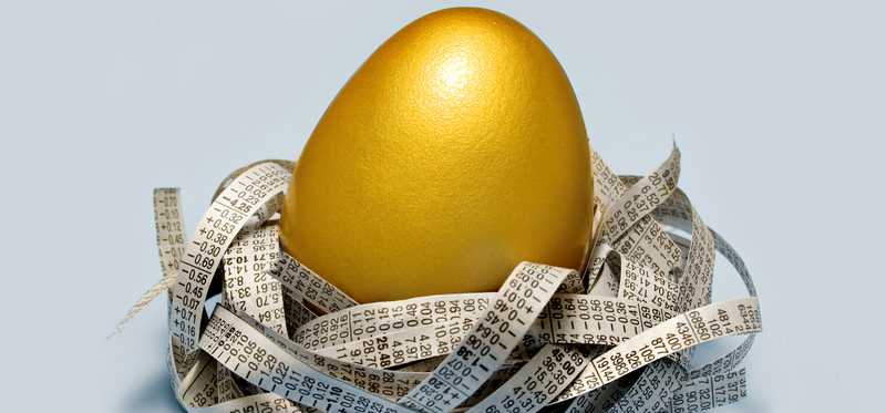 Golden egg surrounded in nest made of paper shreds