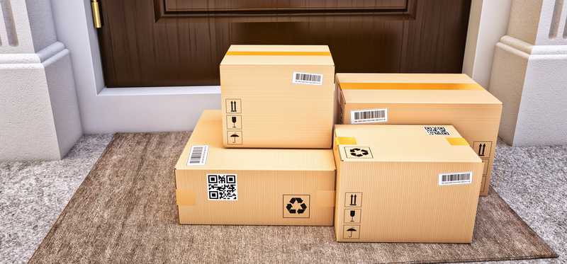 Pile of boxes on front porch by a door