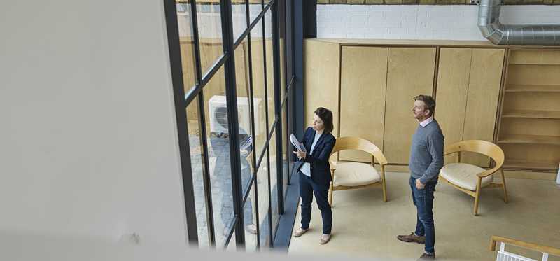 Real estate agent showing a customer a commercial property.