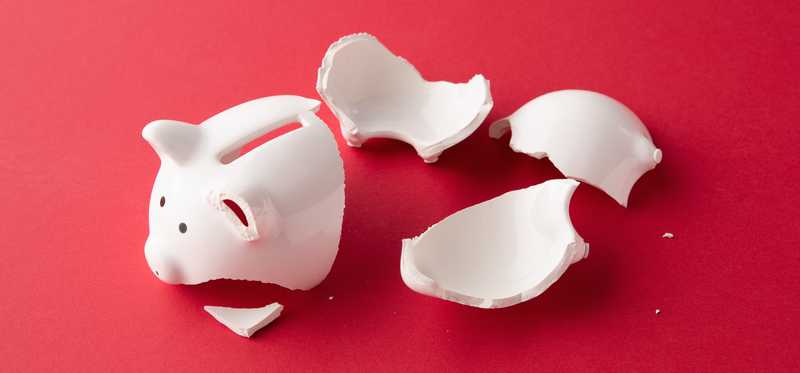 Broken piggy bank lying in pieces.
