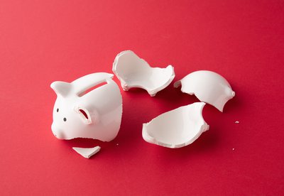 Broken piggy bank lying in pieces.