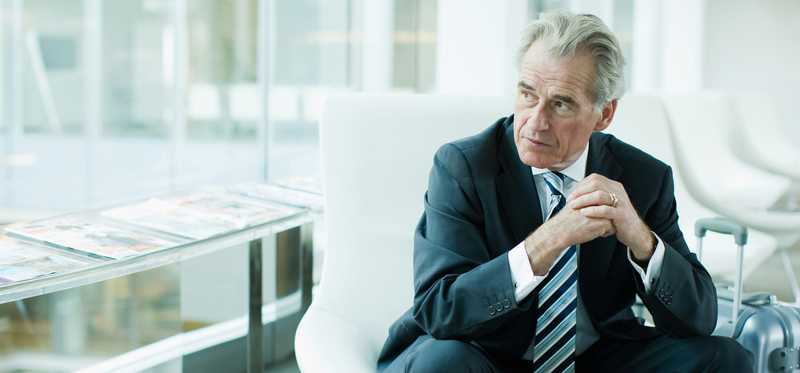 Person sitting in office and looking out window.