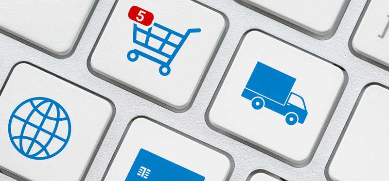 Computer keyboard with truck and shopping cart icons.