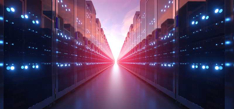Rows of computer servers against backdrop of pink sky